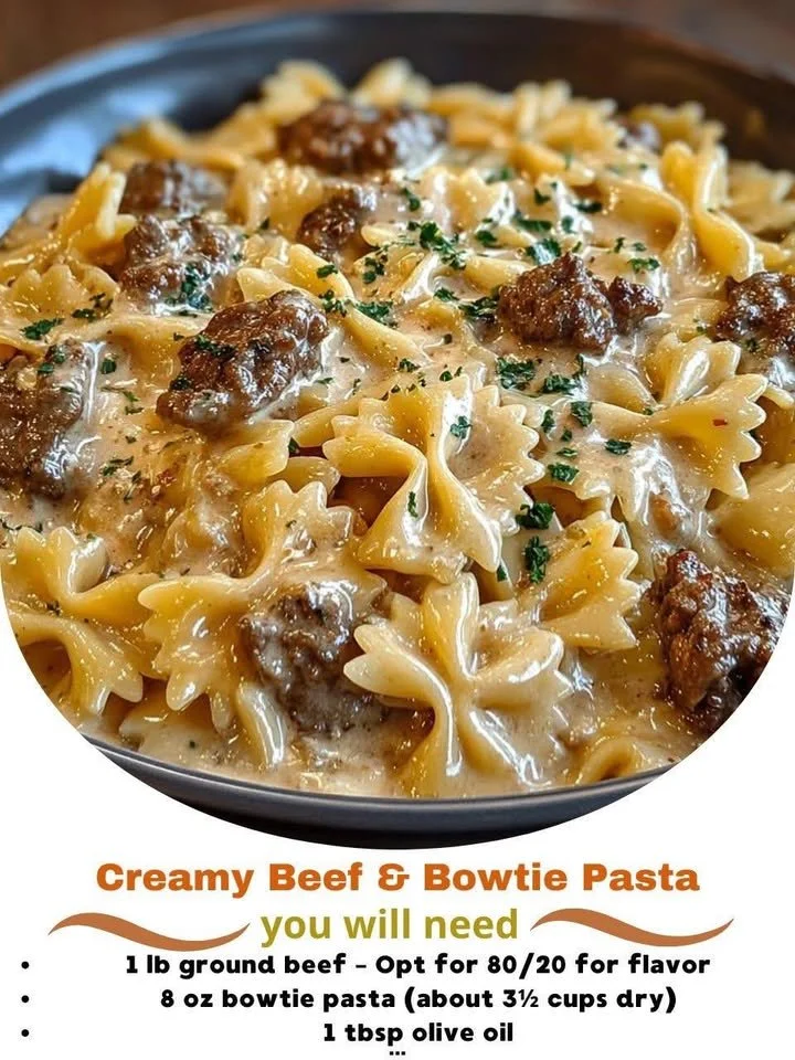 Creamy beef and bowtie pasta dish garnished with herbs