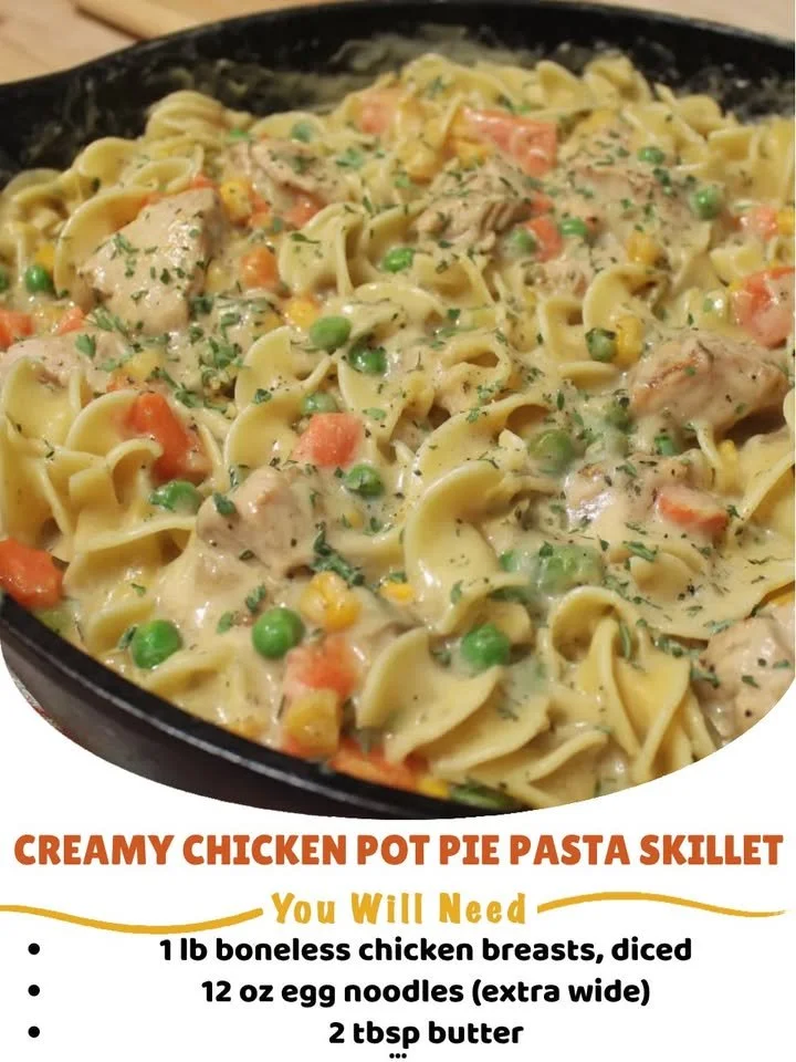 Creamy chicken pot pie pasta skillet with vegetables in a cast-iron pan
