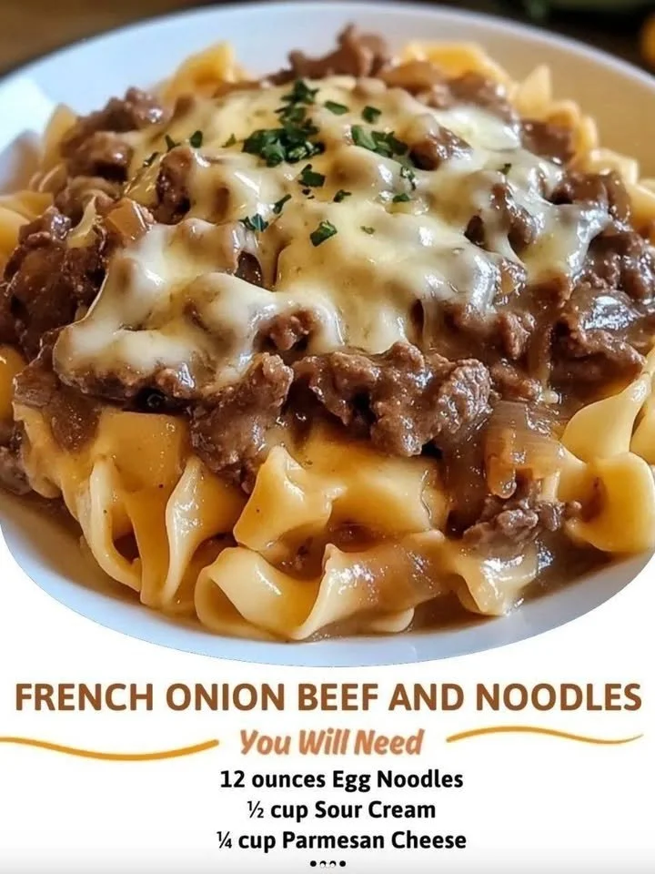 Delicious bowl of French onion beef and noodles topped with melted cheese