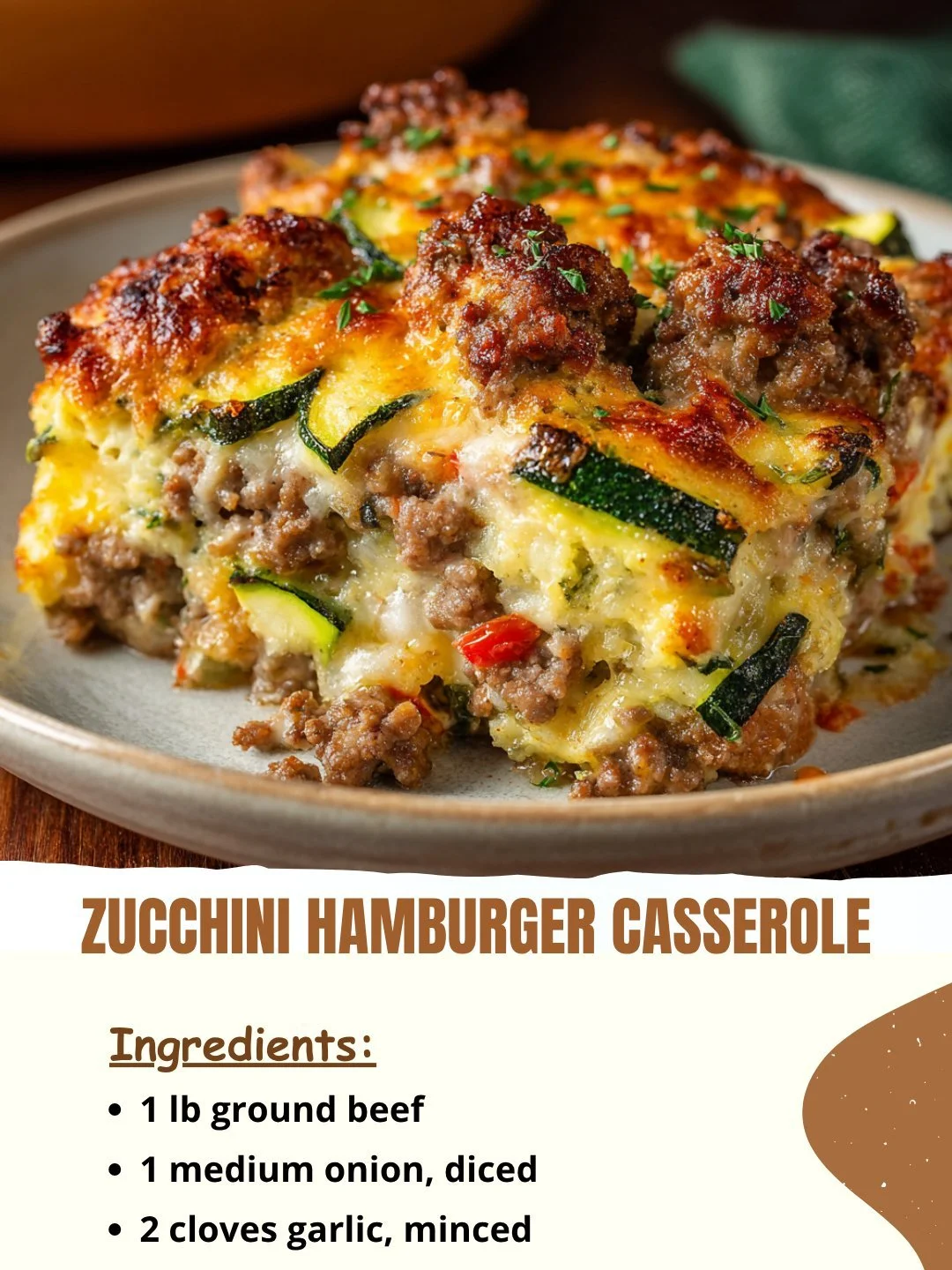 Zucchini Hamburger Casserole topped with melted cheese and fresh herbs