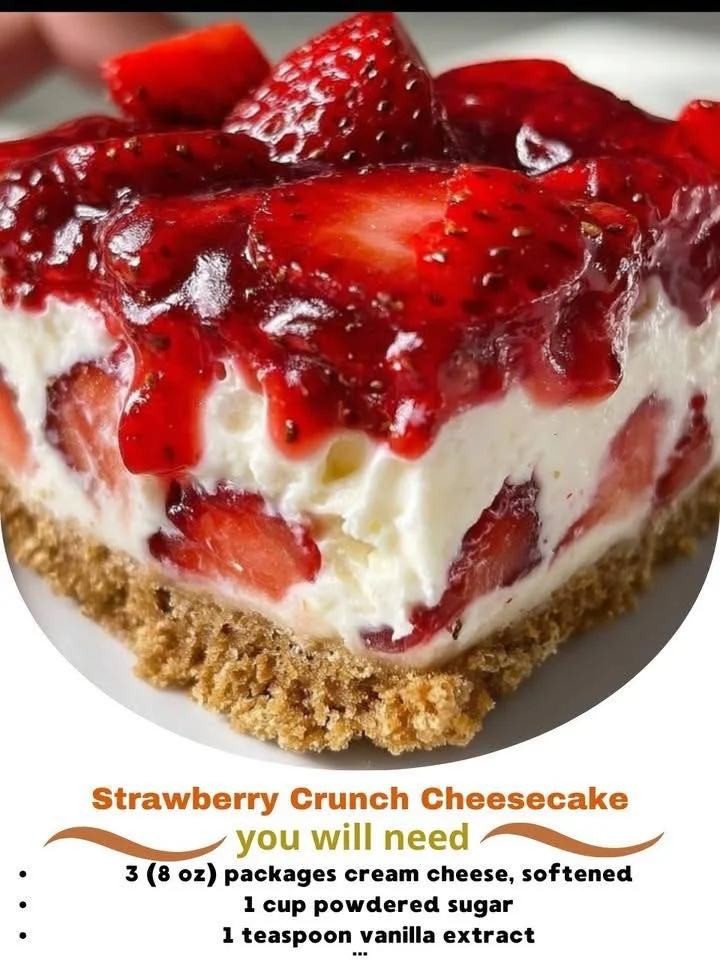 Slice of Strawberry Crunch Cheesecake with fresh strawberries and crunchy topping